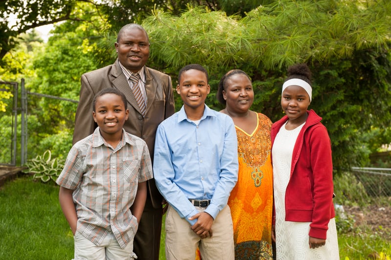 Moses and his family outside their home