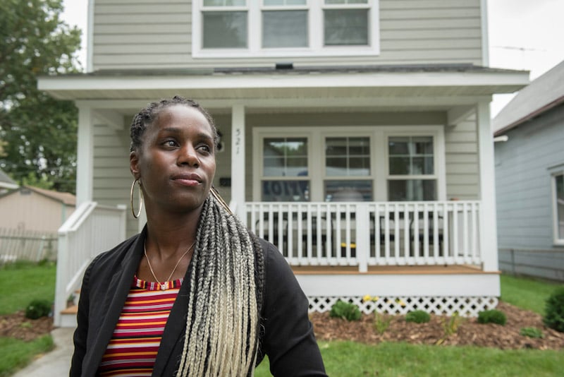 LeAndra in front of her Habitat home.