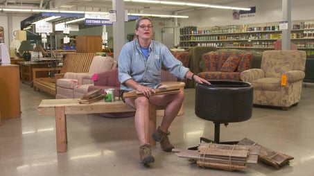 ReStore Manager Jan Hagerman sitting next to her DIY fireplace