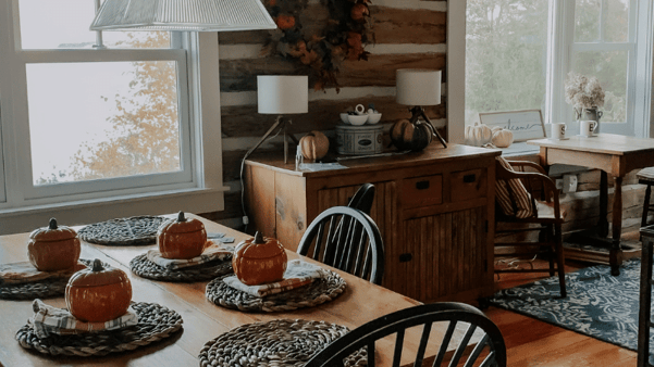 A dining room all decked out with autumn-themed decor.