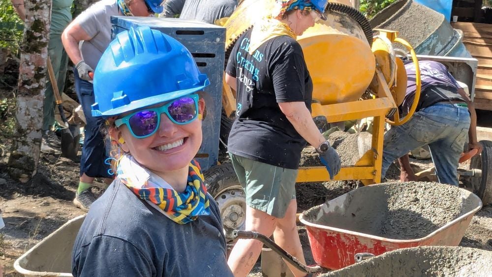 Volunteer using a wheelbarrow in the Dominican Republic.