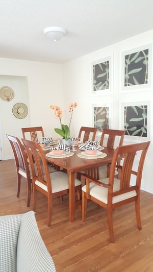 A kitchen with wood floors and furniture.