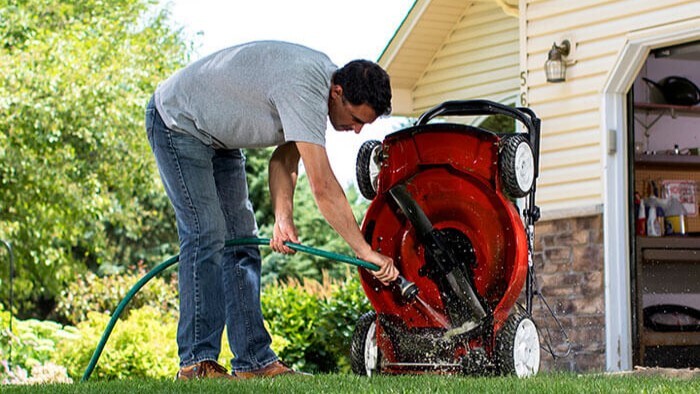 Cleaning a lawn mower.