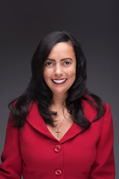 Headshot of Mino Leon in a red jacket.