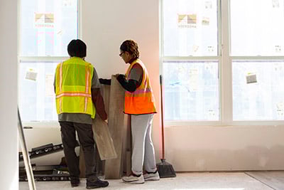 Realtors installing cabinets.