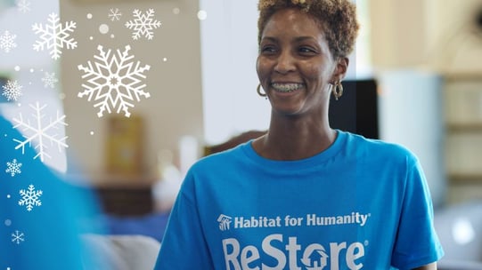 A smilng person in a blue ReStore t-shirt.