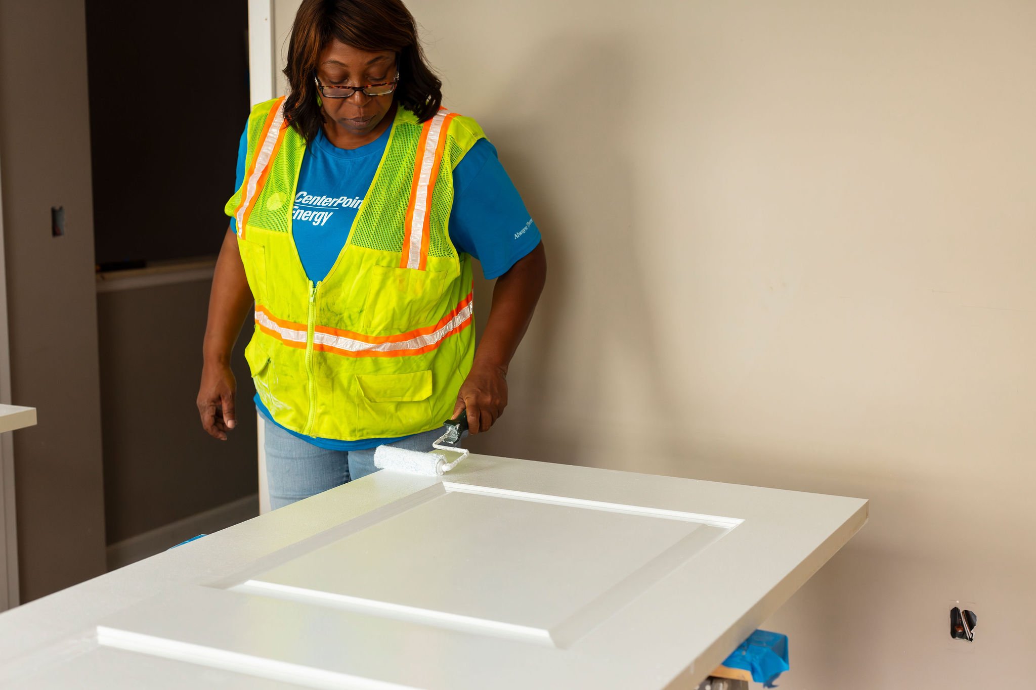 Volunteer painting door.