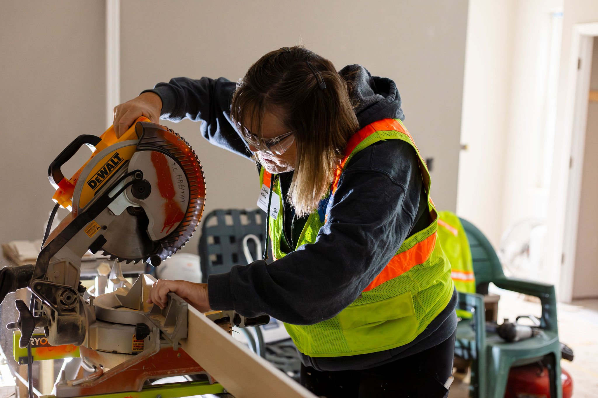Volunteer using saw.