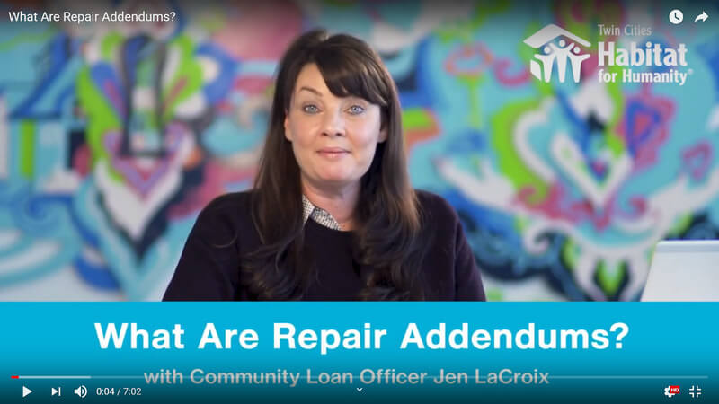 Jen LaCroix speaking against a colorful background. A blue banner at the bottom has white text that says 