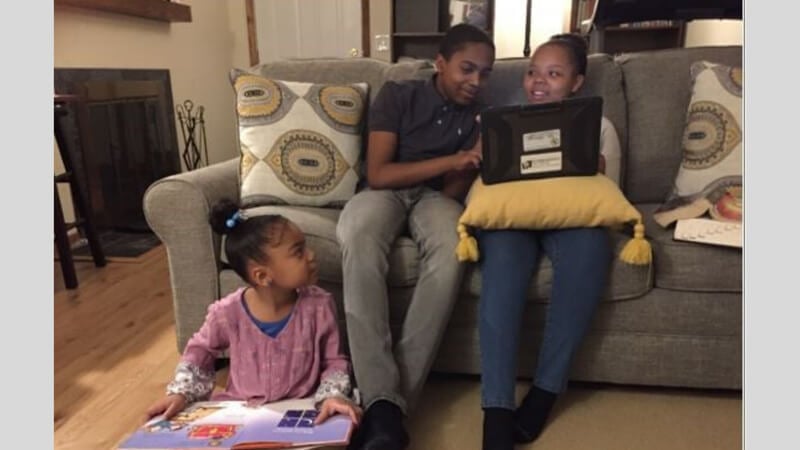 Don helping his sisters with homework.