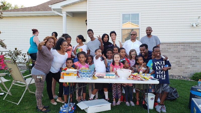 A group of people gathered around a picnic table.