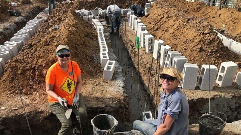 Volunteers working on the foundation of a home.