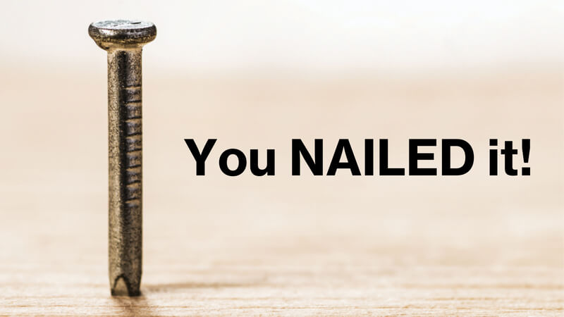 An image of a nail standing up on a wood surface, and the words 