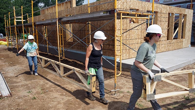 builder's circle members working together outside on a sunny day