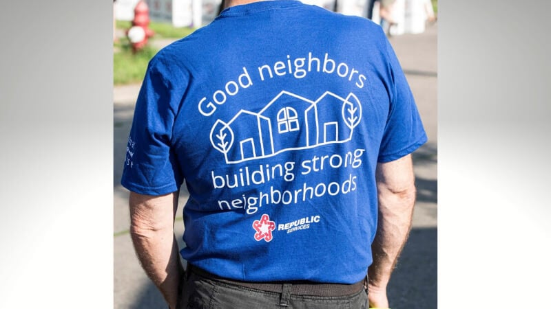 A man wearing a blue t-shirt saying "Good neighbors building strong neighborhoods, Republic Services"