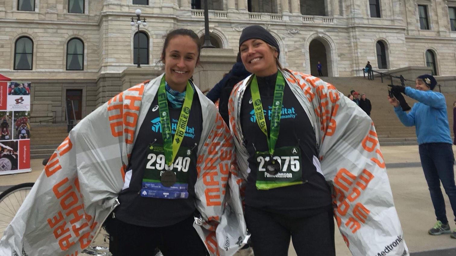 Pam Johnson and her niece Gracia stand with medals they received from running in the 2019 Twin Cities Marathon