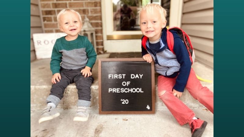 Bethany's children next to a first day of school sign