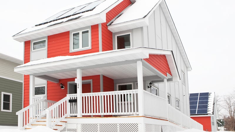 Habitat home with solar panels on the roof and the garage.