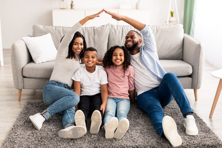 BIPOC homeowner family with two adults and two kids