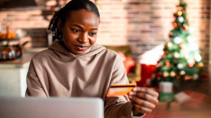 Woman looking at a credit card.