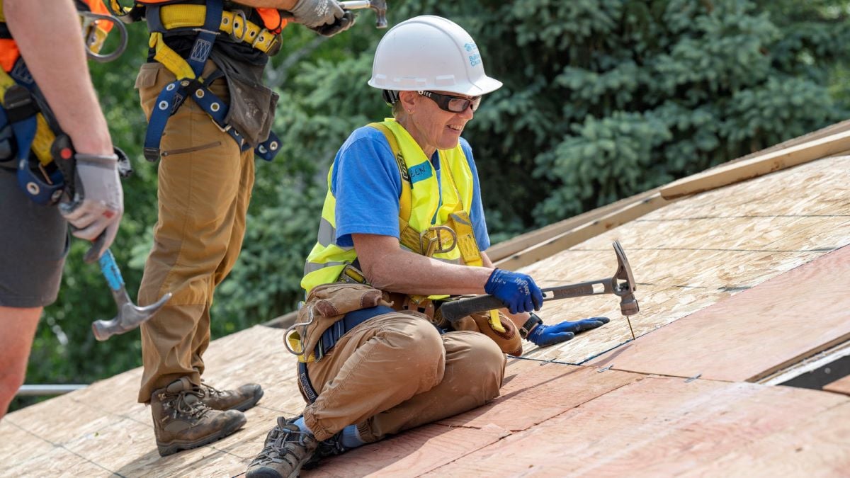 Kathleen working on a roof.