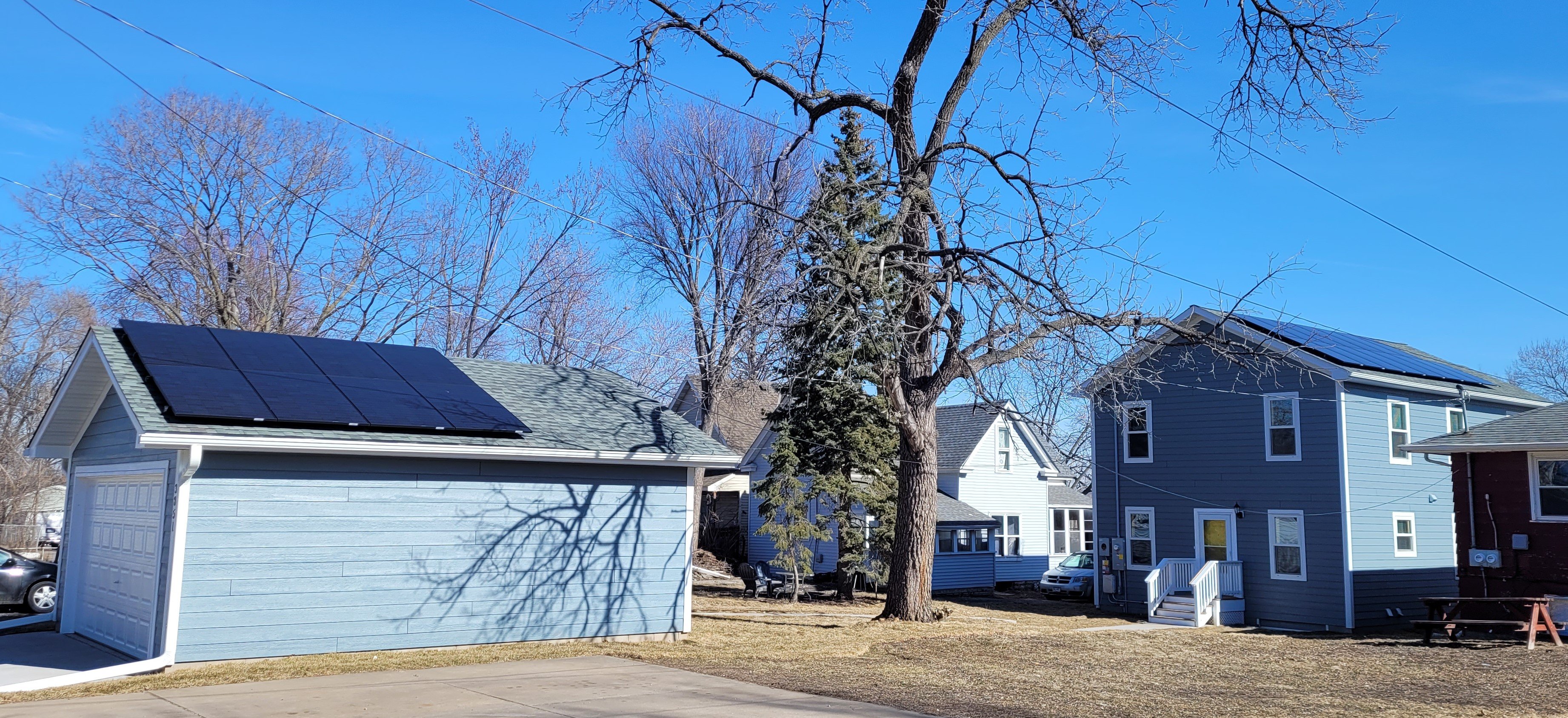 Two solar panels on the garage and roof of a Habitat Home
