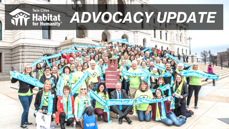 A group of housing advocates in front of the MN State Capitol, with a transparent box at the top with the Twin Cities Habitat logo and 