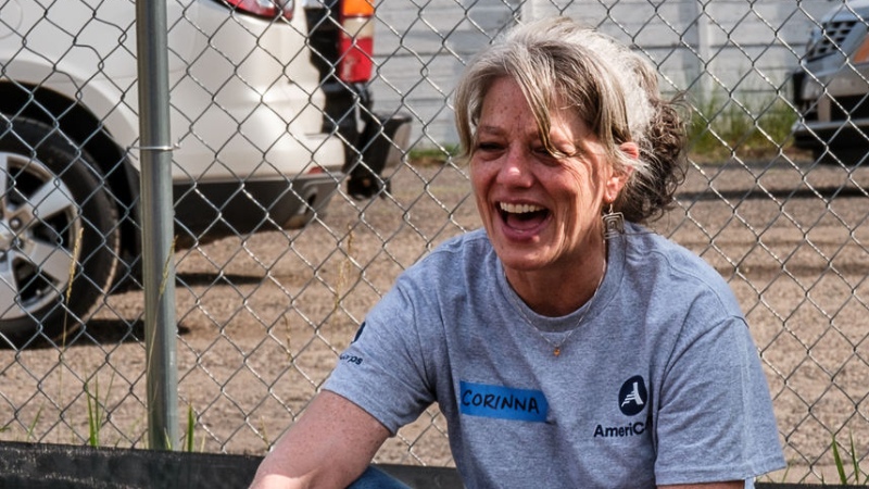 Corinna laughing and smiling on a build site.