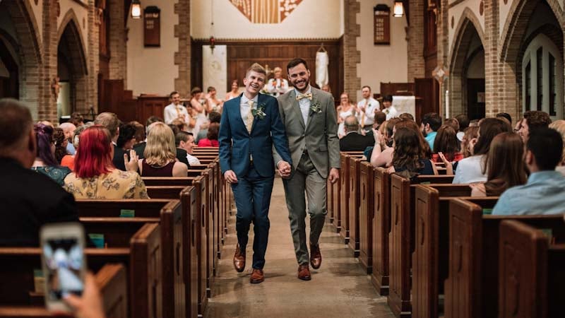 Blake and Greg walking down the aisle at their wedding