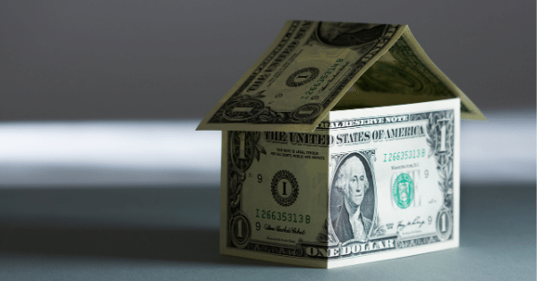 A tiny home that is shaped out of dollar bills