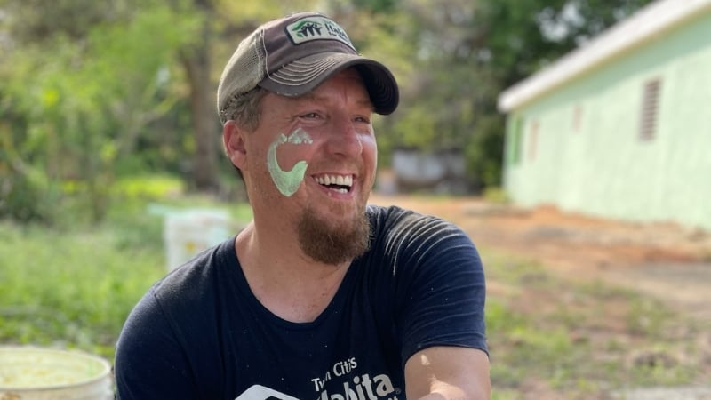 Corey smiling with green paint on his cheek.