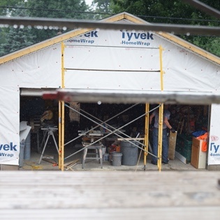 Tenacious Volunteers Work in the Rain on Habitat Build Site