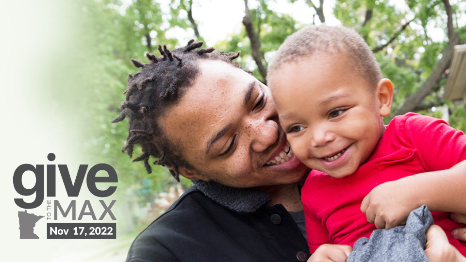 A man holding a child. They both are smiling. Text says Give to the Max November 17, 2022