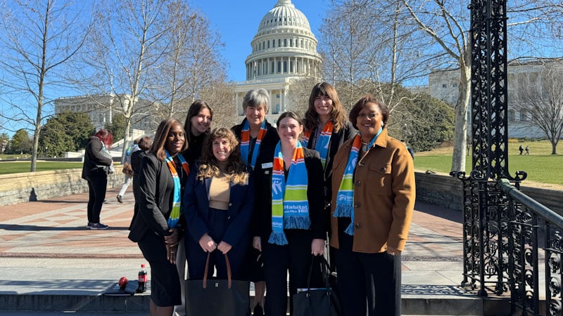 A group of Habitat for Humanity advocates standing in front of the U.S. Capitol buidling