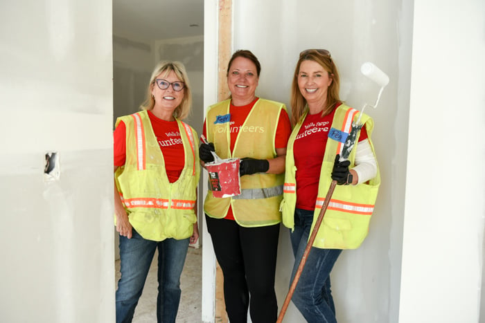 Three volunteers in reflective vests.