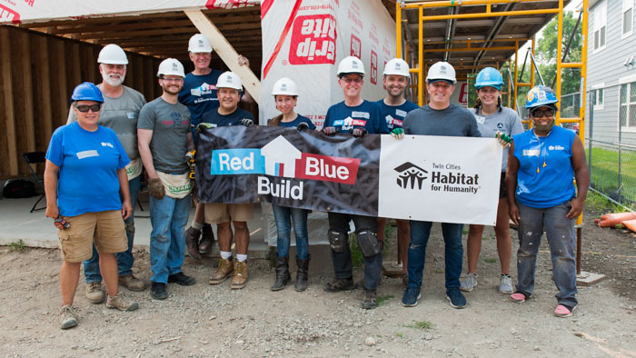 State legislators and Habitat staff holding a sign that says Red Blue Build.