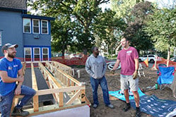 Volunteers working on foundation outside.