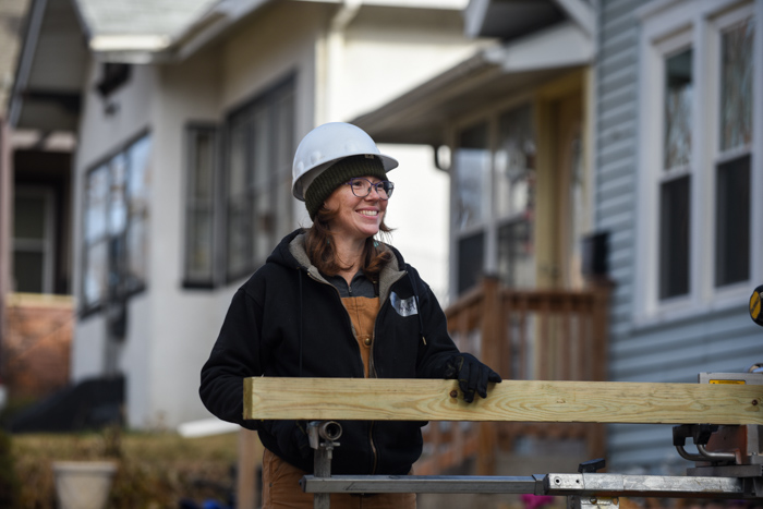 Volunteer holding beam.