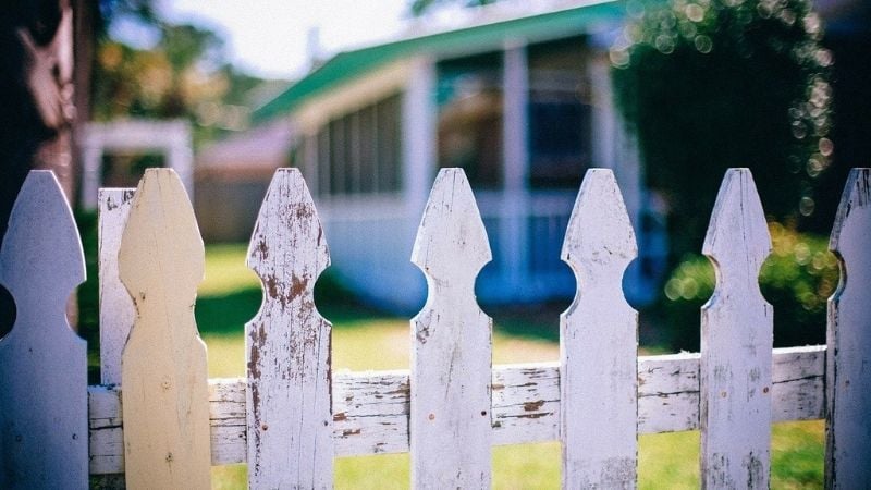 Close up image of a white picket fence