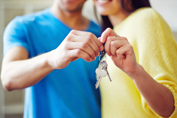 two people holding one set of keys