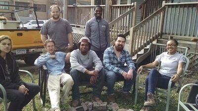 AmeriCorps members relaxing on a yard.