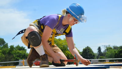 A volunteer on a roof.