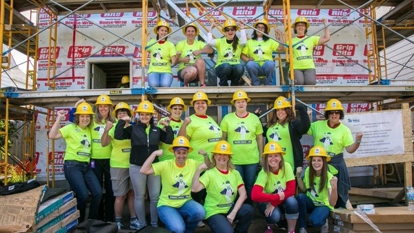 A group of women smiling at a build site.
