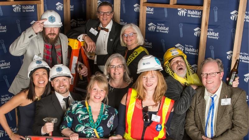 Guests acting silly in hard hats and construction garb in the photo booth.