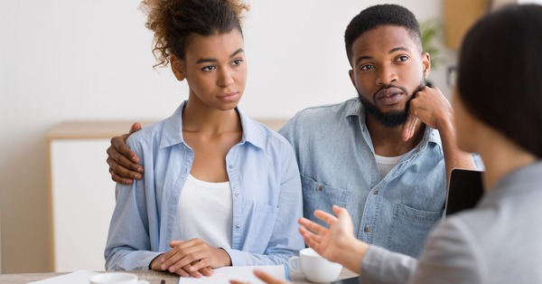 First-time homebuyer couple speaking with a financial advisor on using their 401(k) to buy a home.