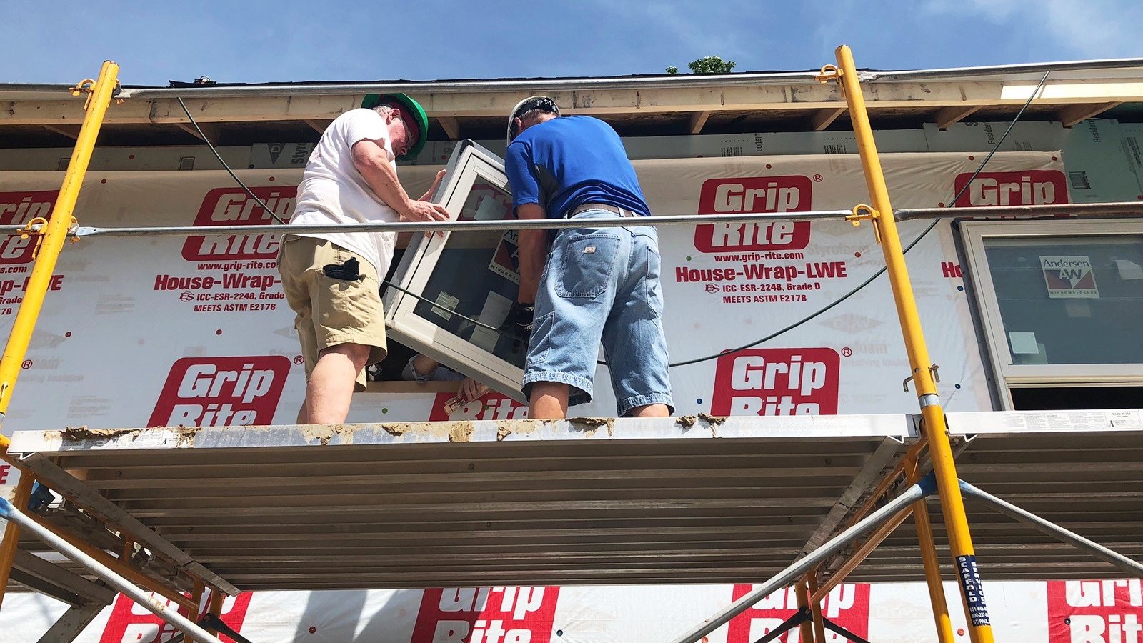 Installing a window during the neighbors' build day