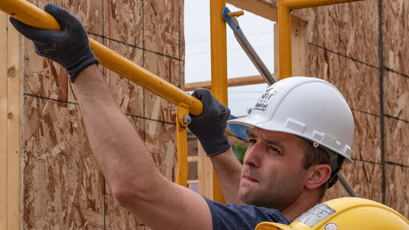 Campaign Council member Jake Loesch volunteering on a Habitat build site.