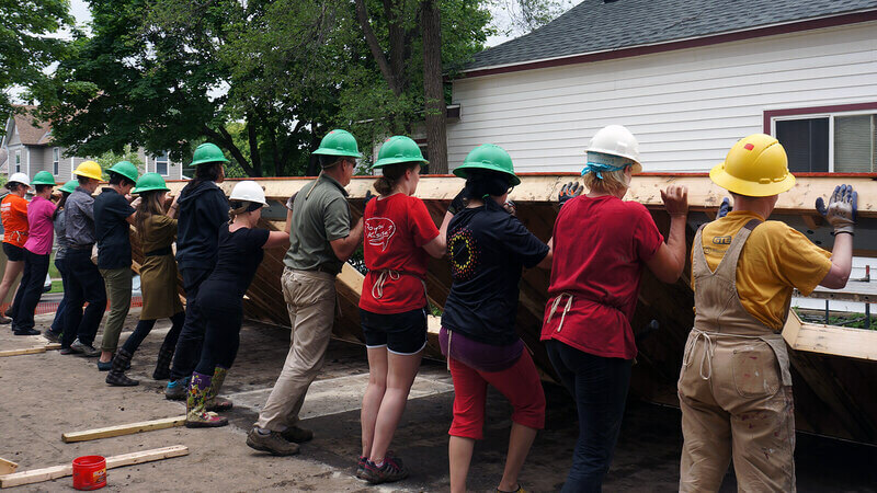 Sunrise volunteers raising the first wall on the Habitat home the bank sponsored in 2016.