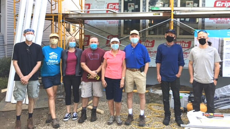  The Olson family and friends volunteering together on the home they sponsored. Karen is in the middle (pink shirt), with David next to her (blue shirt).