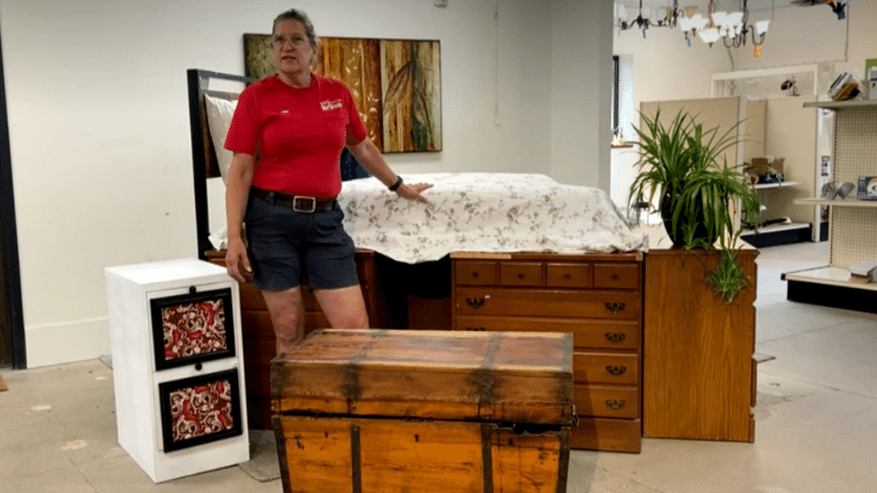 Jan showing off a bed on top of a set of dresser drawers.